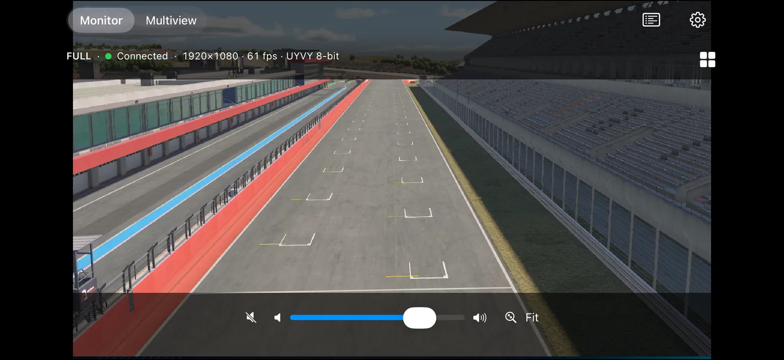 NDI MViewer monitor on iPhone in landscape: a racetrack feed filling the screen, stats line 1920×1080 · 61 fps · UYVY 8-bit, volume slider and Fit button